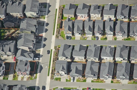 Aerial view of rows of houses and a commuter car heading to workの写真素材