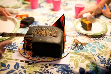 Birthday cake is cut by knifeの写真素材