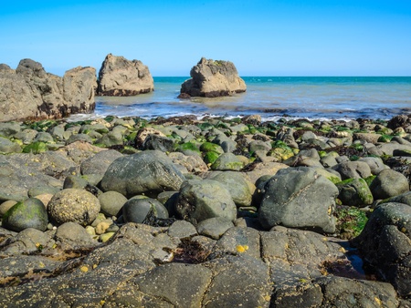 A rock strewn beach on the North Antrim Coast, Irelandの写真素材