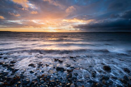 Dawn on Belfast Lough, viewed from Downshire beach, Carrickfergus, County Antrim, Northern Ireland.の写真素材