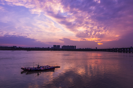 fishing boat on river under sunset sceneryのeditorial素材