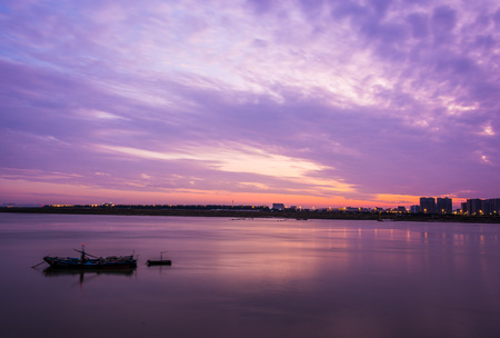 fishing boat on river under sunset sceneryのeditorial素材