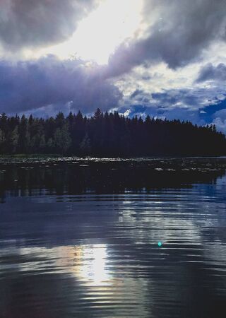 ripples on a stormy reflective lakeの写真素材