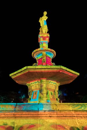 Illuminated statue and fountainの写真素材