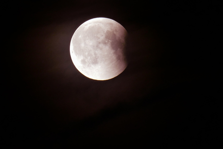 Lunar eclipse in dark night sky - final stage