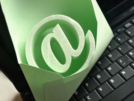 An @ symbol in the envelope standing on the keyboard.の写真素材