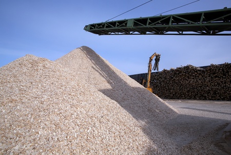 The mountain wood chips on a wood stock is replenished by loader