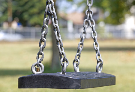 Empty chain swing in playground at park .の写真素材
