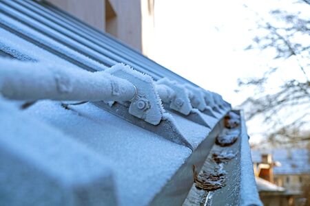 icicles which are hanging down from a roof.の写真素材