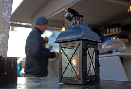 Lantern with candle and light, sundown in the mountains on the background