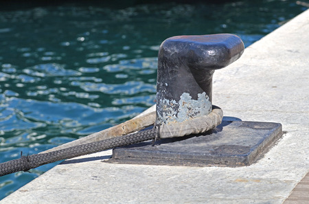 a bollard with a rope on the pier