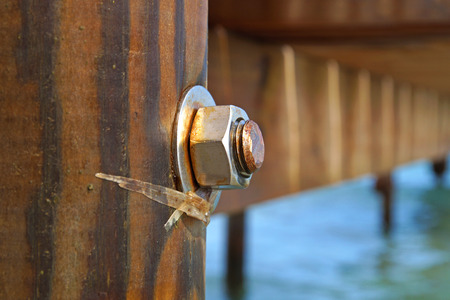 image of the wood, the bolt, nut in the pier at sea