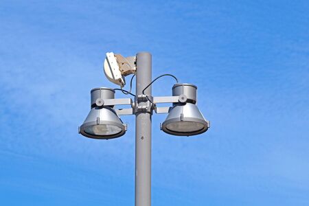 Closeup of a modern white metallic street lamppost with five lanterns against clear blue sky. Copy...