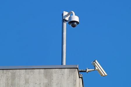 Surveillance cameras against blue sky. Security Cctv
