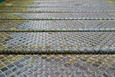 Steel plate slip old metal floor sheet,rusty texture, metallic , industry background, aluminum surfaces , industrial shiny silver with rhombus shapes.の写真素材