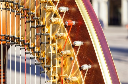 Part of musical instrument called harp in abstract background .の写真素材