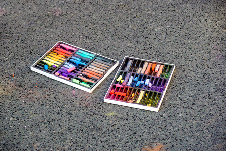 Colored chalks. Colored chalk on playground with drawings on street