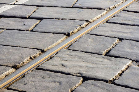 close up of tram tracks crossing each other .