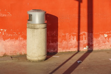 trash can trashcan dustbin garbage rubbish bins waste round outside in street against brick wall with brick copy space residential .の写真素材