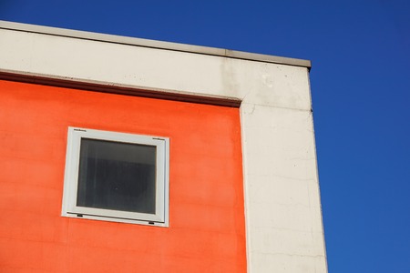 Architecture. Red facade of a building with windows. Colorful facadeの写真素材