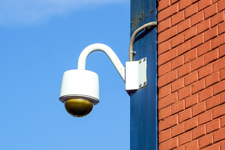 High tech overhead security camera with dark thunderstorm sky.