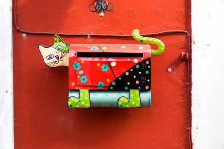 mailbox metal made in shape of a cat, on red wallの写真素材