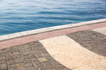 Perspective View of Grunge Cracked White Marble Brick Stone on The Ground for Street Road near lake . Sidewalk, Driveway, Pavers, Pavement in Vintage Design Flooring Square Pattern Texture Backgroundの写真素材