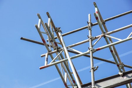 metal scaffolding in building and blue sky background .の写真素材