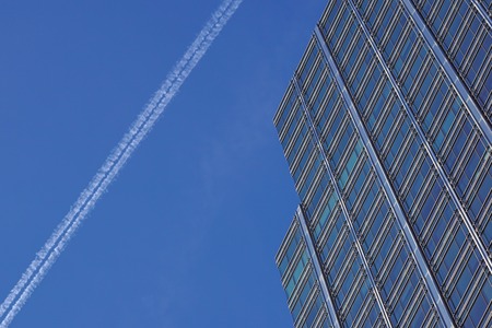 Perspective and underside angle view to textured background of contemporary glass building skyscrapersの写真素材