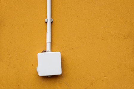 electrical box for splicing out door,on yellow wall