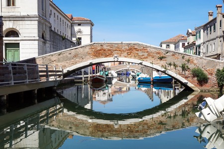 Venice, Italy - 7 july ,2017 : View of the house characteristics of the lagoon of Venice in italy along the canals with moored boats. Venice is the city on the seaのeditorial素材