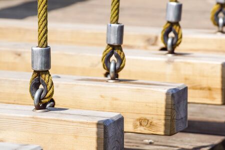 Old wooden swing so rusty on hookの写真素材