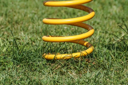 Playground toy spring detail on the grassの写真素材