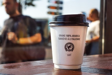 Nice , France -02 august 2017 : Paper coffee cup from coffee shop on wooden backgroundのeditorial素材