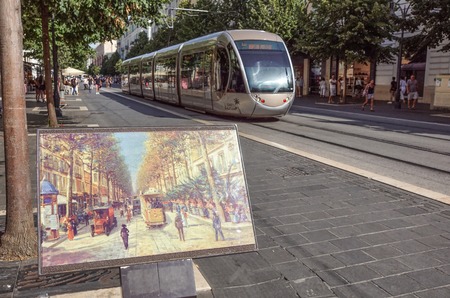 Nice, France - September 2 2017: Modern tram in Place Massena in the late afternoon with a painting of an old tramのeditorial素材