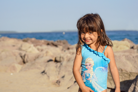 NICE, FRANCE - August 2017 : her little girl smiles and plays at the happy beach of Nice in Franceのeditorial素材