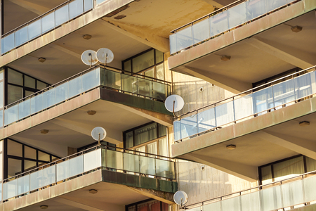 Facade of the reseidential building with windows and balconies and satelite antennasの写真素材
