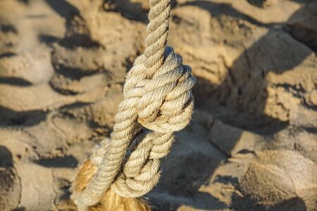 Detail of rope railing of beach walkway, at sunset .の写真素材