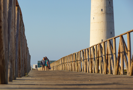 Fuerteventura , Spain 13 june 2017 : Couple walking on the walkway lane path near beach at sunset.のeditorial素材