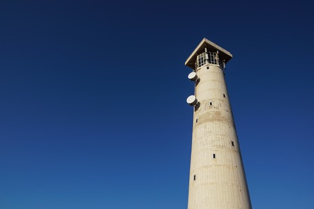 sunny morning the lighthouse of Morro Jable in Fuerteventura island with blue sky in background