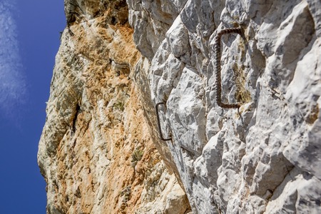 Old hook and surface of natural grungy marble abstract on rocky wallの写真素材