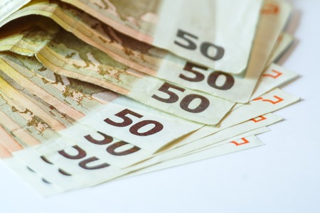 Fifty euro banknotes on white wooden background