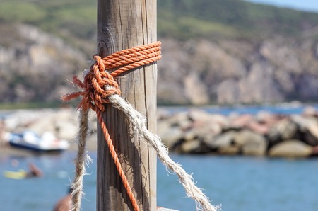 Fragment of nautical rope fence with weathered woodenの写真素材