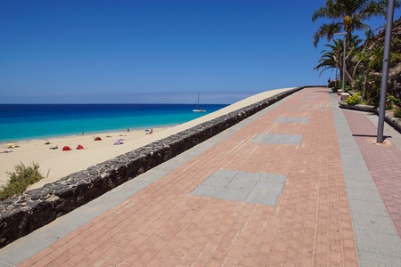 Promenade with tropical plants and flowers along a beach in Morro Jable holiday village, Fuerteventura, Canary Islands, Spainの写真素材