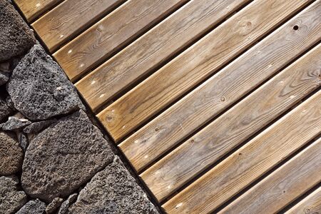 Stone wall background. stone and wood wall, wood texture as background. Wood background wall .の写真素材