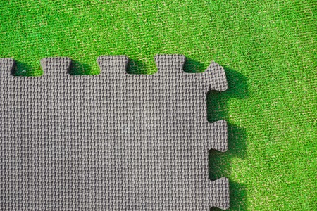 Jigsaw puzzle pieces on bright green background, horizontal viewの写真素材