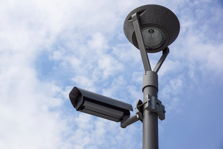 Security Camera in a Modern Building and cloud sky backgroundの写真素材