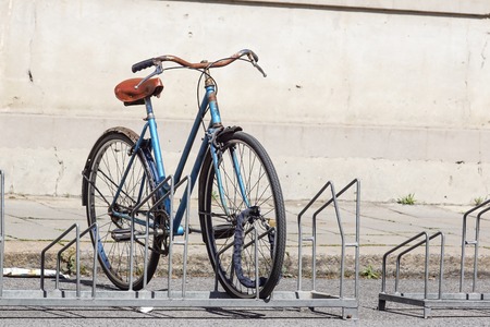 Bicycle parked in the street on the bicycle rackの写真素材