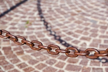 Old rust massive iron chain on sunlight