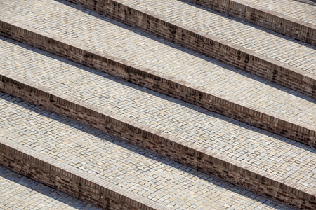 Abstract diagonal stairs, old worn granite staircase on a city square, wide stone stairway...